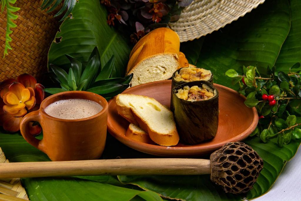 Tamal santandereano, pan de yuca y café en pocillo de barro
